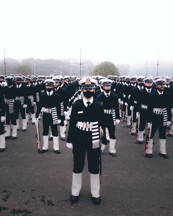 A disciplined group of naval cadets standing in formation during a ceremonial parade.